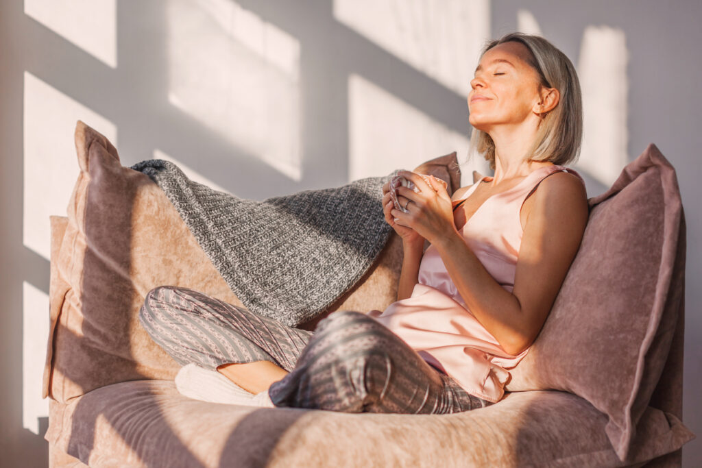 A woman sits with her coffee on a chair enjoying the moment representing Memento Mori: Being Intentional and Living for Meaning