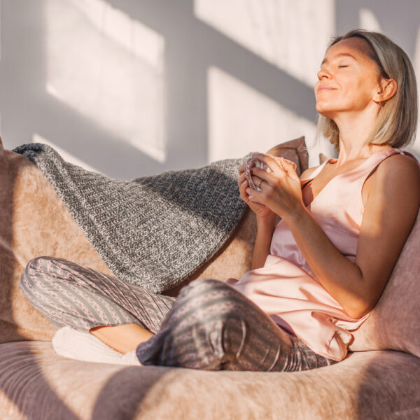 A woman sits with her coffee on a chair enjoying the moment representing Memento Mori: Being Intentional and Living for Meaning