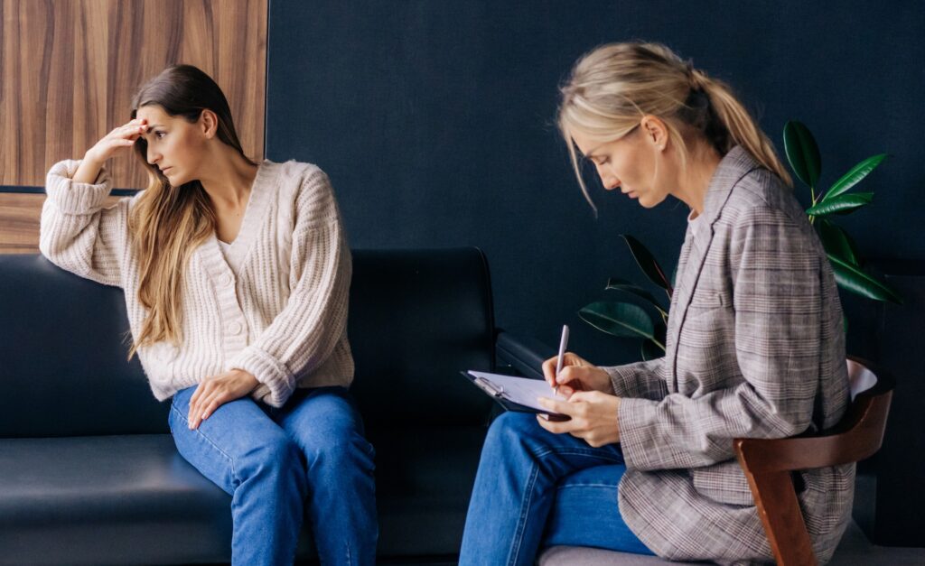 A therapy client sits in her session frustrated that she isn't getting direction or therapist advice representing Do Therapists Give Advice? Finding Direction When Therapy Fails