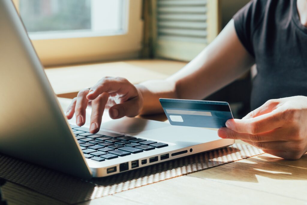 A therapy client pays for self pay therapy using her personal credit card instead of going through insurance representing How to Talk to Therapy Clients About Insurance and Self Pay Therapy