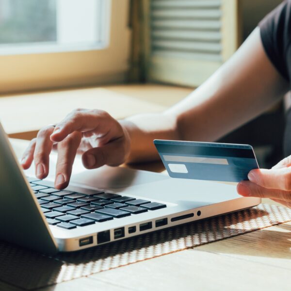 A therapy client pays for self pay therapy using her personal credit card instead of going through insurance representing How to Talk to Therapy Clients About Insurance and Self Pay Therapy