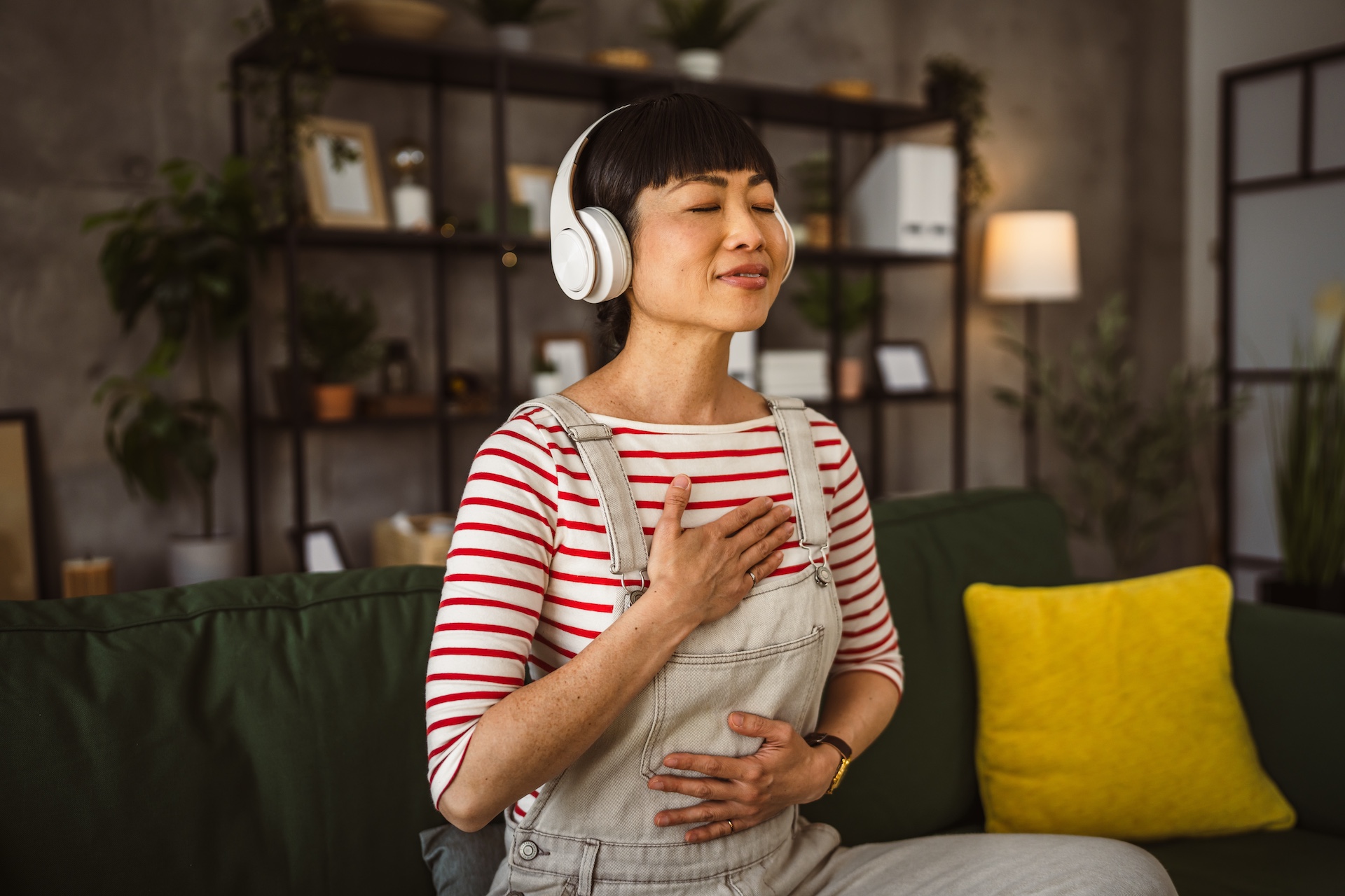 Therapist practicing acceptance commitment therapy through mindful breathing and self-compassion at home