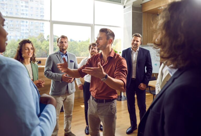 Organizational consultant leading a collaborative discussion with a group of business professionals in a bright, modern office.