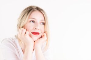 Woman gazing thoughtfully upward, illustrating limerence vs love and the experience of obsessive romantic longing.