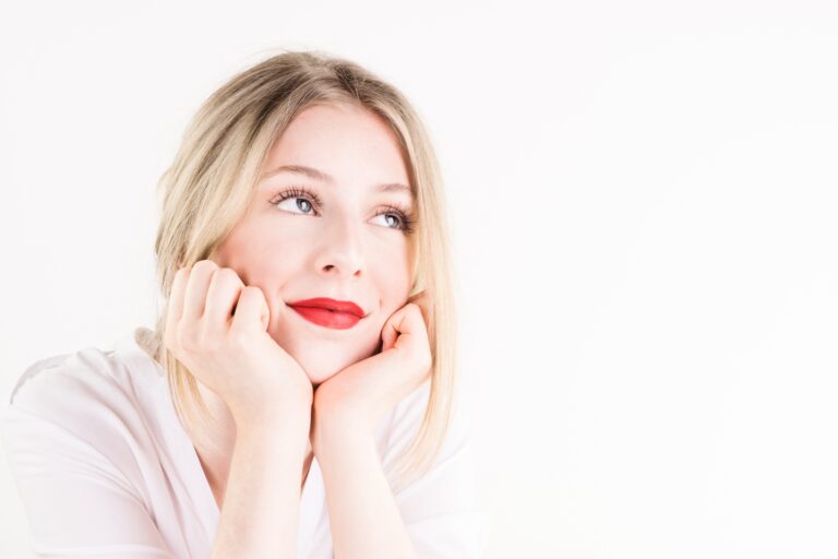 Woman gazing thoughtfully upward, illustrating limerence vs love and the experience of obsessive romantic longing.