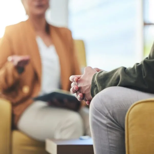Therapist speaking with a client during a counseling session, illustrating therapy for therapists and professional mental health support.